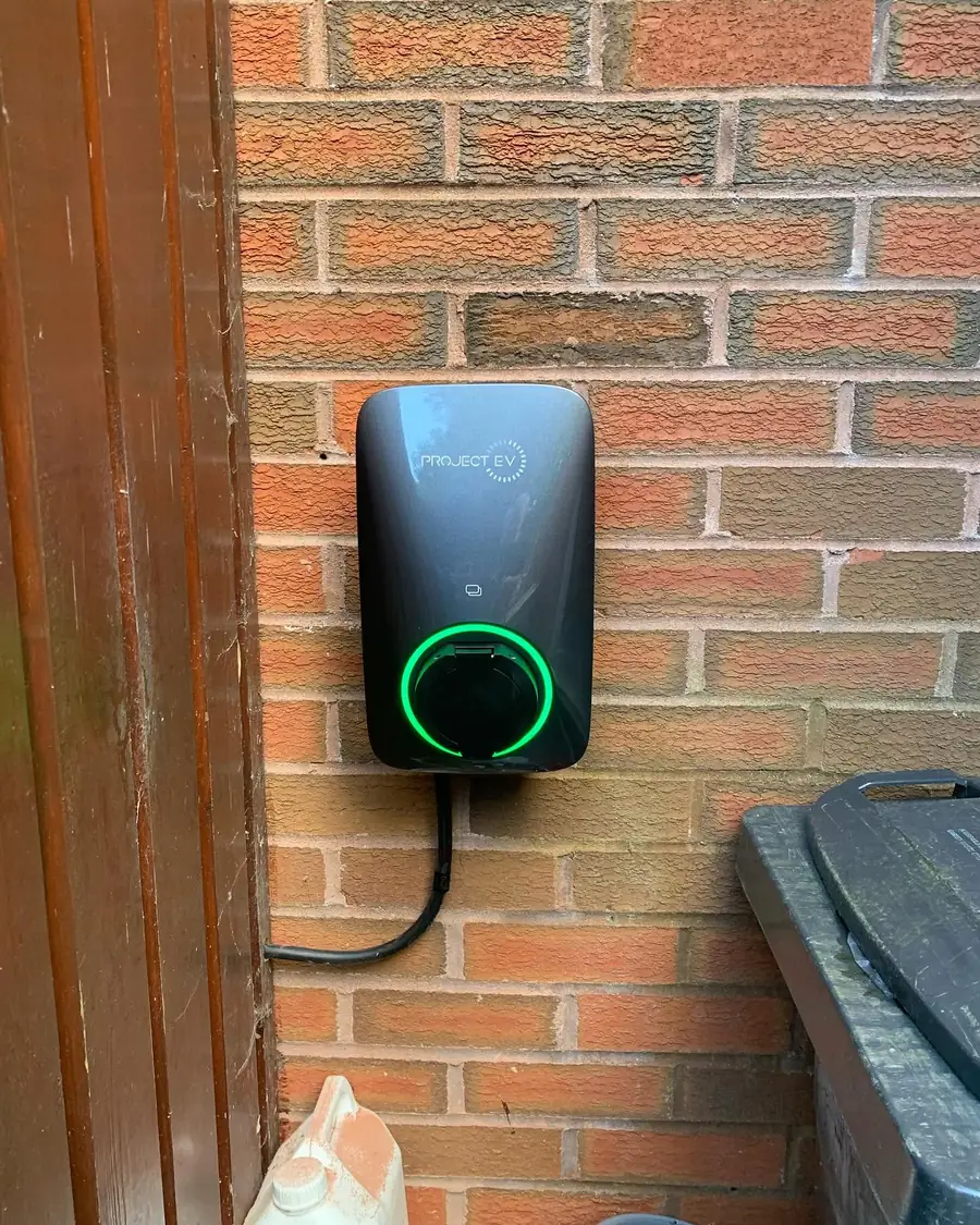 Project EV wall-mounted car charger installed on a brick wall