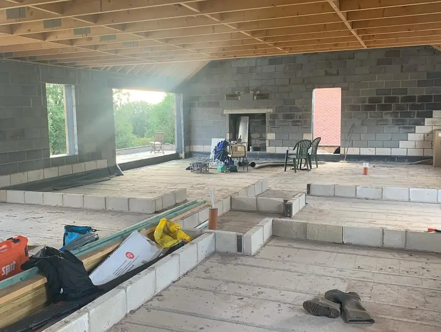 New build interior at first fix stage with exposed timber roof structure