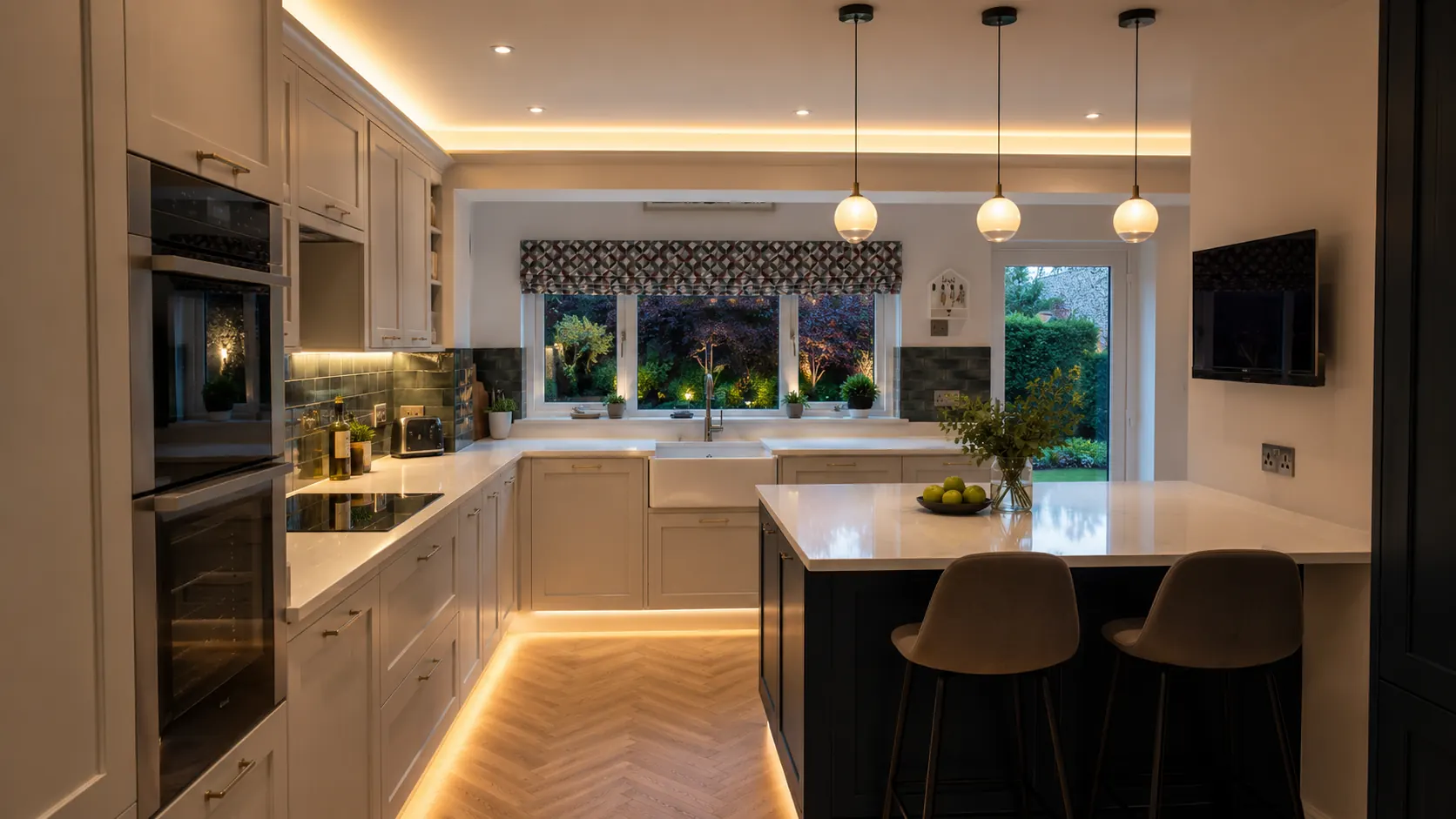 Kitchen at dusk with pendant lighting, cove lighting, under-cabinet and plinth LEDs