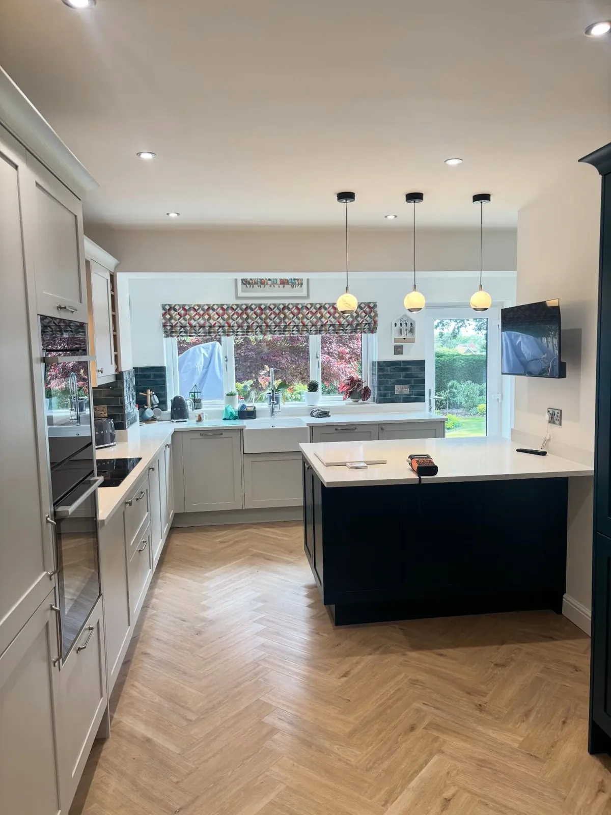 Kitchen with new pendant lighting and recessed downlights installed by A.D. Brookes